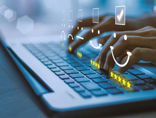 Businesswoman pressing face emoticon on the keyboard laptop .Customer service evaluation concept.blue tone